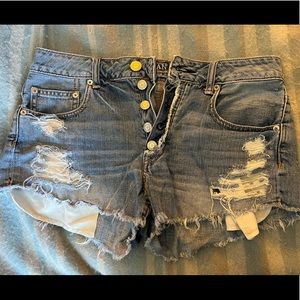 Two pairs of AE button fly jeans shorts; white and jean color. size 8.